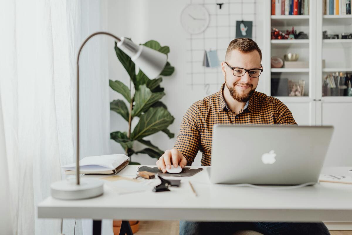 A Nova working at a laptop in a bright home office