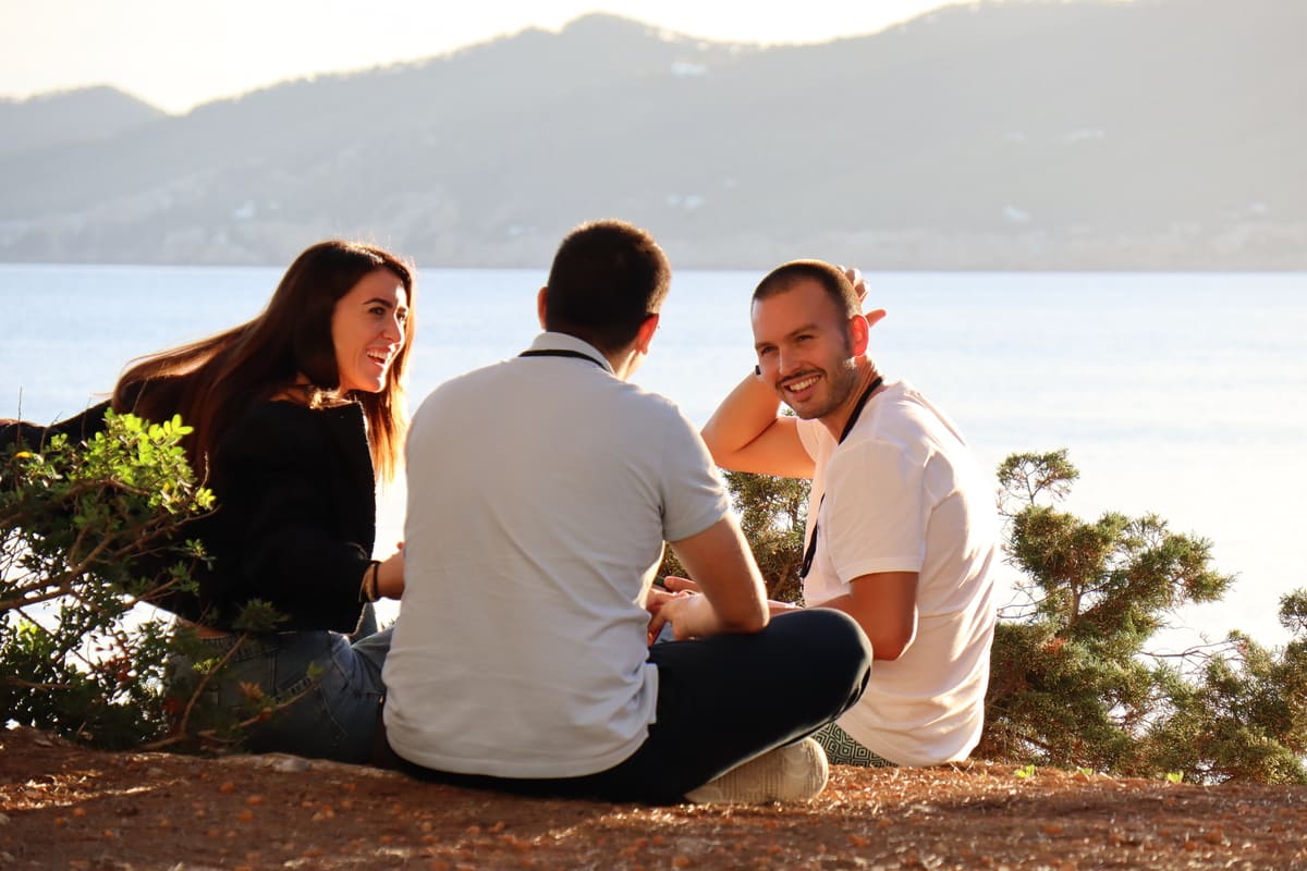 Three Novas sitting together by the water at a Nova retreat