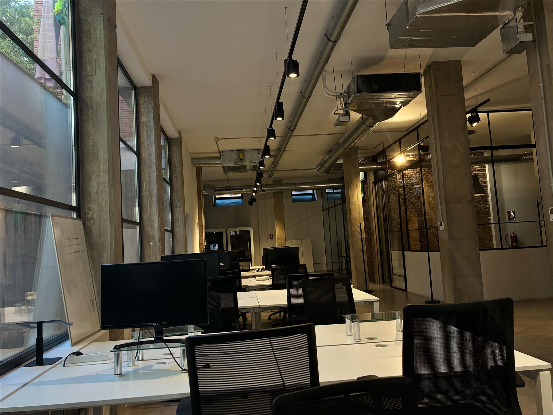 Desks with monitors at The Nova House